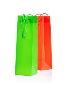 green and yellow paper bags isolated on white