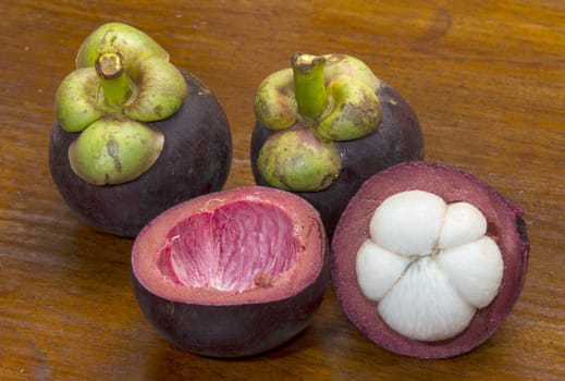 Mangosteen fruits from Thailand cur open to show white flesh. Known as the "Queen of fruits"