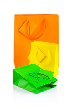 three colored paper bags isolated