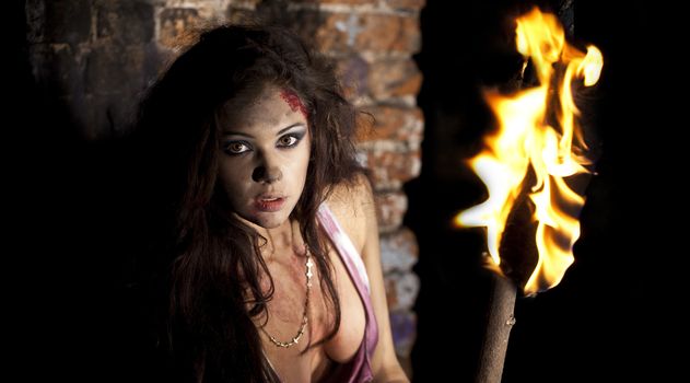 Mysterious sexy woman with torch in hand