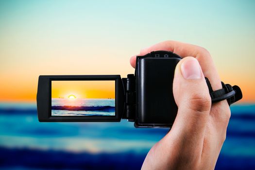 Video camera or camcorder recording sunset