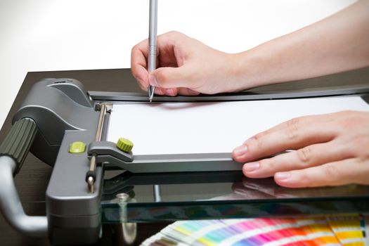 Man working on the guillotine for paper