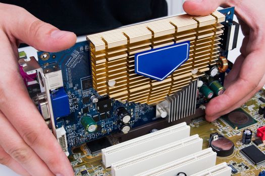 Man install GPU hardware. PC motherboard upgrade
