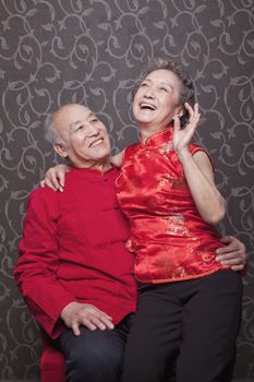 Senior Chinese Couple Laughing in Traditional Clothing