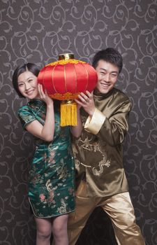 Young Couple Holding Chinese Lantern in Traditional Clothing