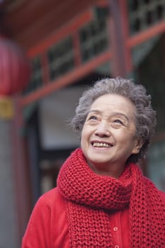 Portrait of senior woman outside a traditional Chinese building