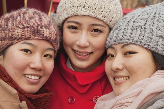 Portrait of three friends outdoors in winter, Beijing