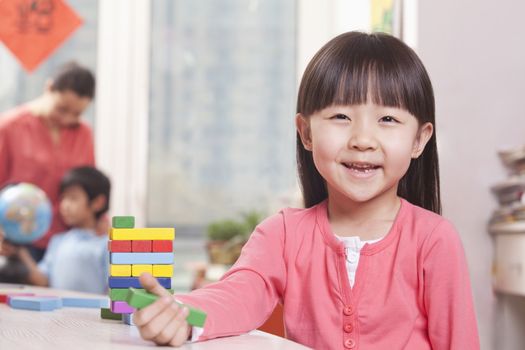 Little Girl Playing with Blocks