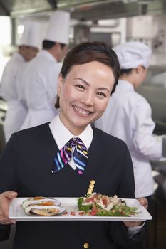 Restaurant Hostess Presenting Gourmet Dish