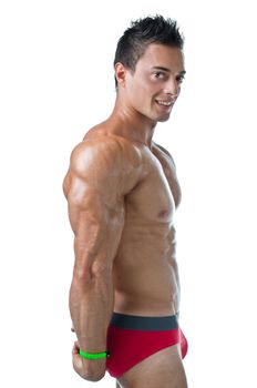 Studio shot of handsome young muscle man doing side triceps pose, smiling. Isolated on white background