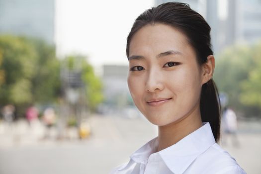 Portrait of young businesswoman smiling outside in Beijing 