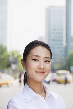 Portrait of young businesswoman smiling outside in Beijing 