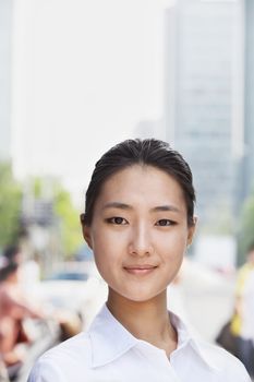 Portrait of young businesswoman smiling outside in Beijing