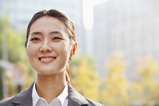 Portrait of young businesswoman smiling outside in Beijing 