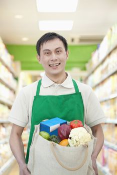 Young Man Holding Shopping Bag with Fruits and Vegetables