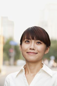 Portrait of young businesswoman laughing outside in Beijing 