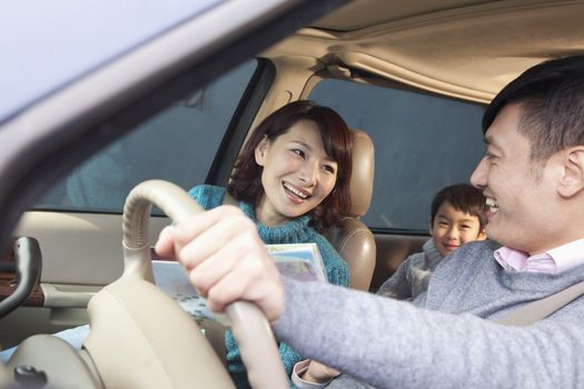 Family sitting in car, Beijing 