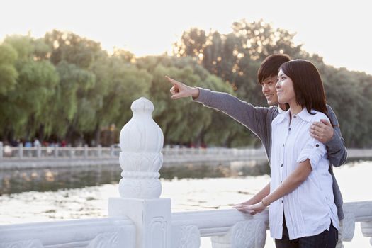 Young Couple Pointing by a Lake