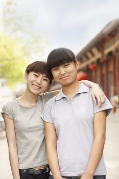 Women smiling and embracing outdoors 