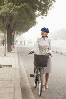 Young Business Woman commuting with a Bicycle, Beijing, China