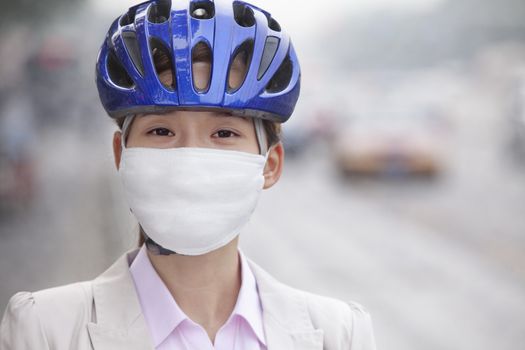 Young Business Woman Wearing Bicycle Helmet and Face Mask