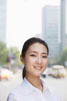 Portrait of young businesswoman smiling outside in Beijing