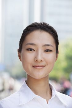 Portrait of young businesswoman smiling outside in Beijing 