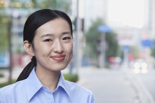 Portrait of young businesswoman smiling in Beijing