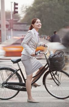 Young Business Woman commuting with a Bicycle, Beijing, China