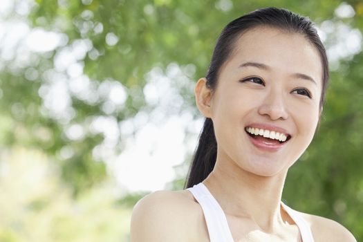 Portrait of Young Woman in Park