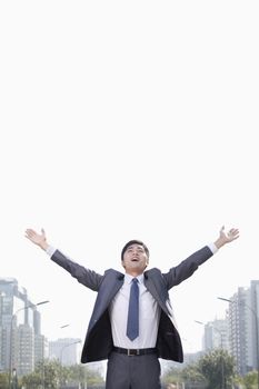 Young Businessman with Arms Raised