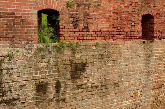 Brick wall with gun portholes at Fort Clinch State Park in Florida. The fort was used during the Civil War.