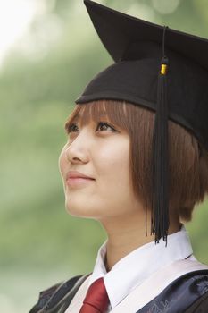 Young Woman Graduating From University, Looking-Up Horizontal Portrait