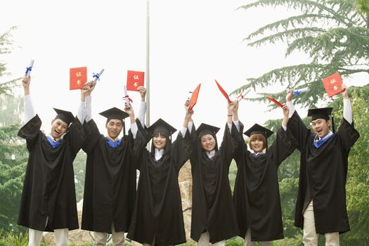 Young Group of University Graduates With Diplomas in Hand
