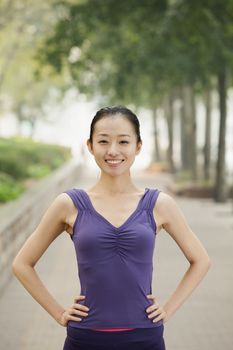 Confident Young Woman in Exercise Clothes in the Park