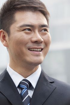 Young Businessman Smiling and Looking Away, Portrait