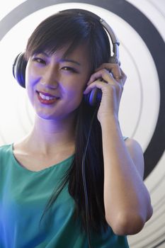 A portrait of a female DJ playing music in a nightclub