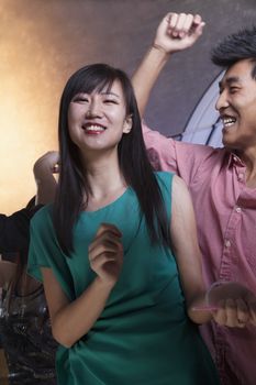 A young woman dancing with friends in a nightclub