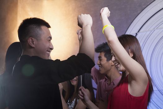 A group of young friends dancing in a nightclub