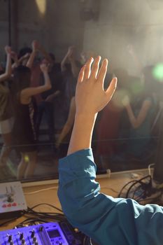 A view from the DJ's deck of a crowd dancing in a nightclub