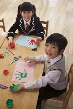 School children finger painting in art class, Beijing