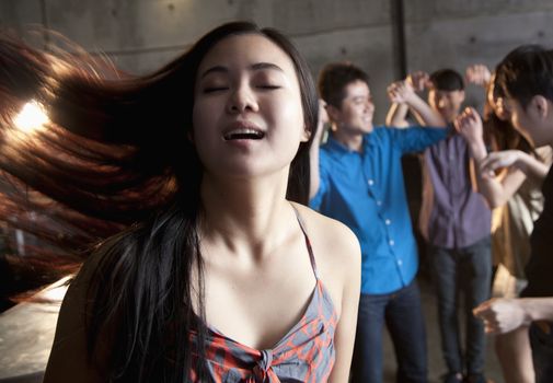 Young woman dancing with her eyes closed