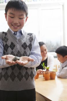 Schoolboy holding a little turtle in his hands, Beijing