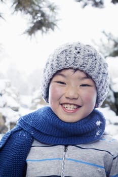 Smiling boy in the snow, portrait