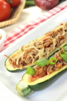 delicious stuffed zucchini with ground beef and cheeseon a light background
