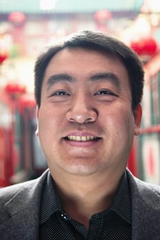 Portrait of mid adult man with Chinese lanterns in background