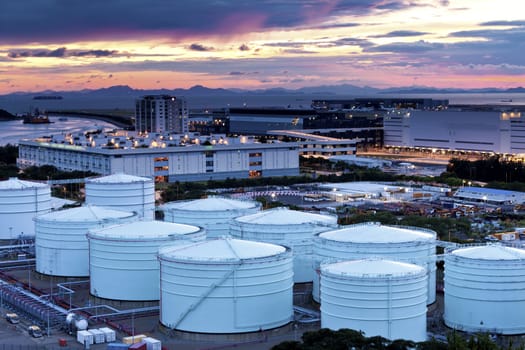 Oil and gas refinery tanks at twilight