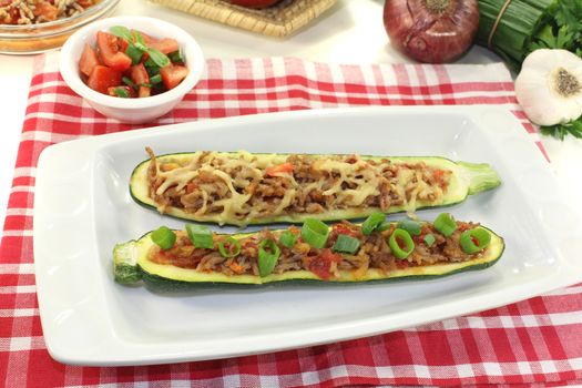 stuffed zucchini with ground beef and cheese on a light background