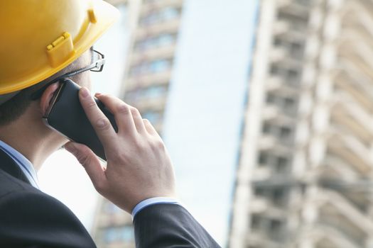 Architect on the phone at a construction site