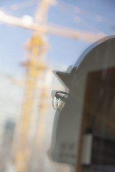 Close-up of reflection of architect on construction site   